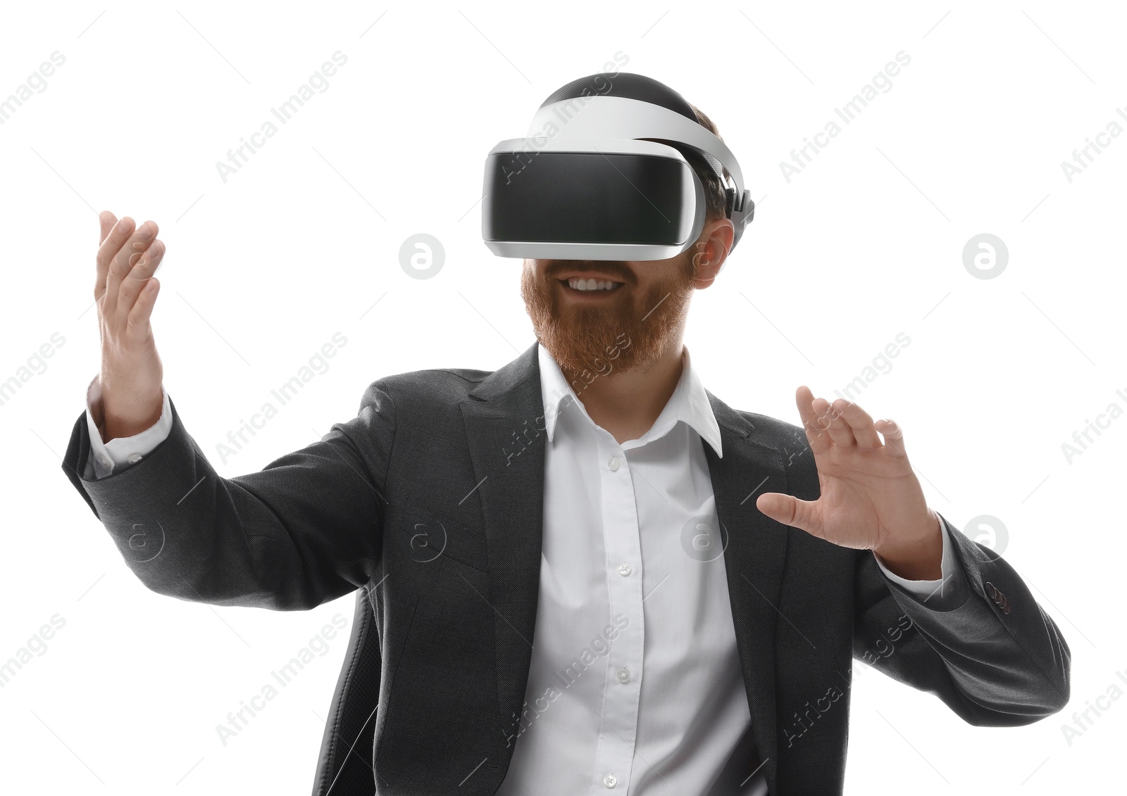 Photo of Smiling man using virtual reality headset while sitting in office chair on white background