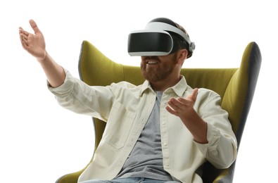 Man using virtual reality headset while sitting in armchair on white background