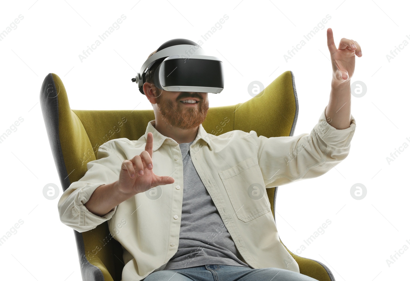 Photo of Man using virtual reality headset while sitting in armchair on white background