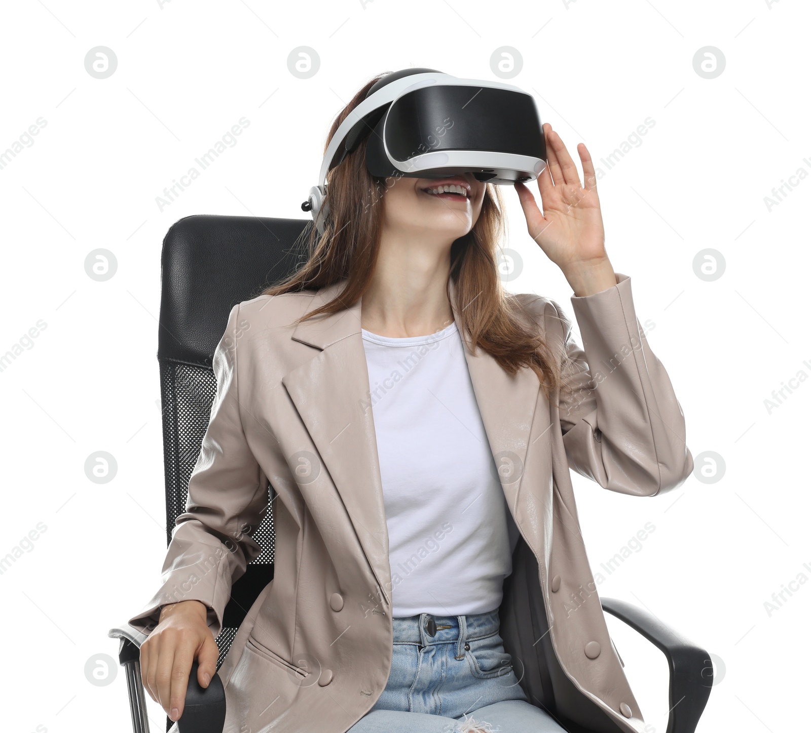 Photo of Smiling woman using virtual reality headset while sitting in office chair on white background