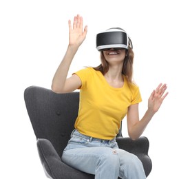 Photo of Smiling woman using virtual reality headset while sitting in armchair against white background