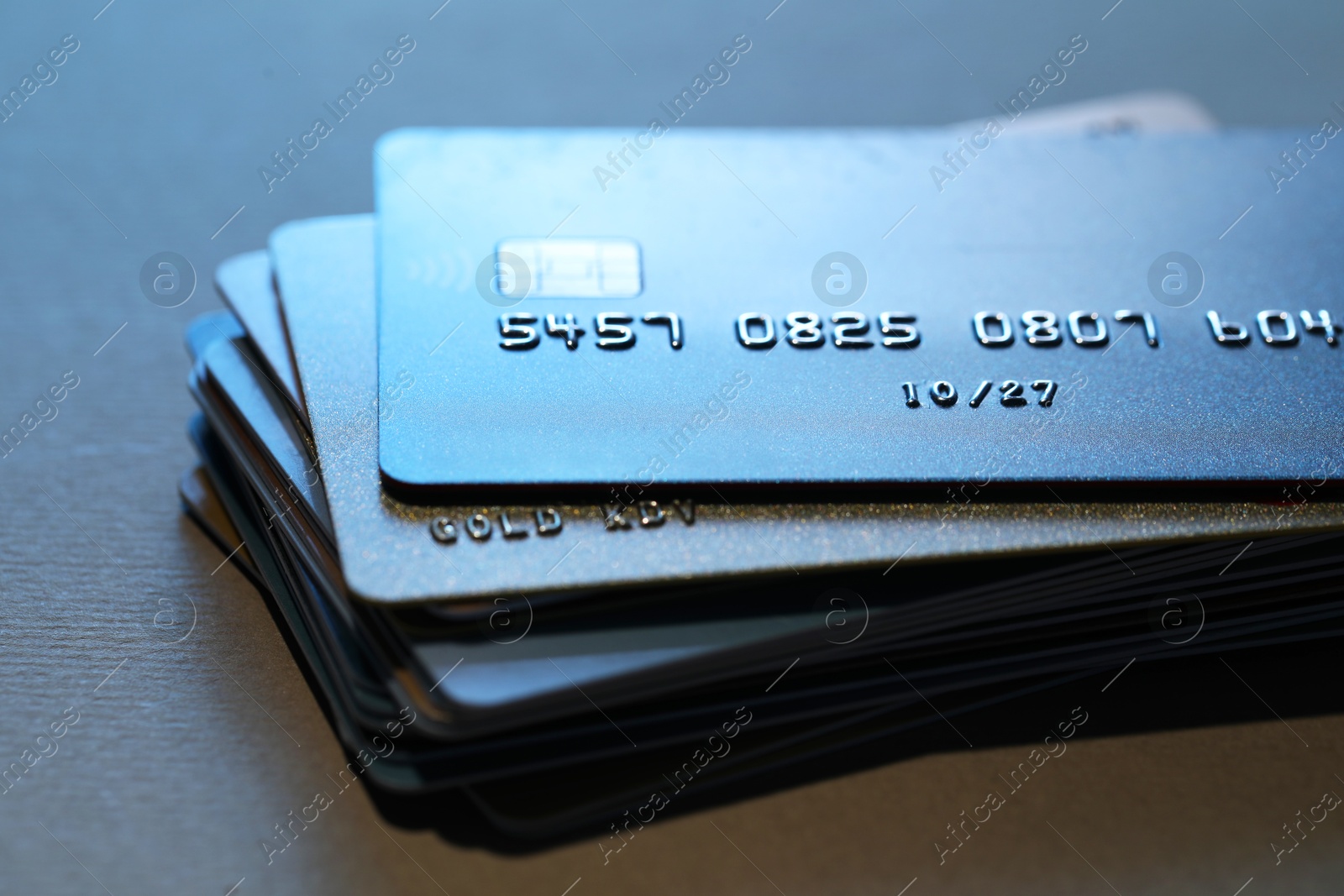 Photo of Many credit cards on gray background, closeup view