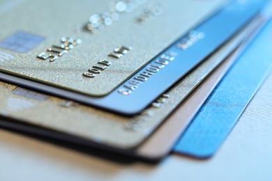 Many credit cards on gray background, closeup view