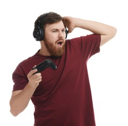 Photo of Emotional man in headphones with game controller on white background