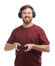 Happy man in headphones with game controller on white background