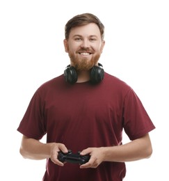 Happy man with game controller and headphones on white background