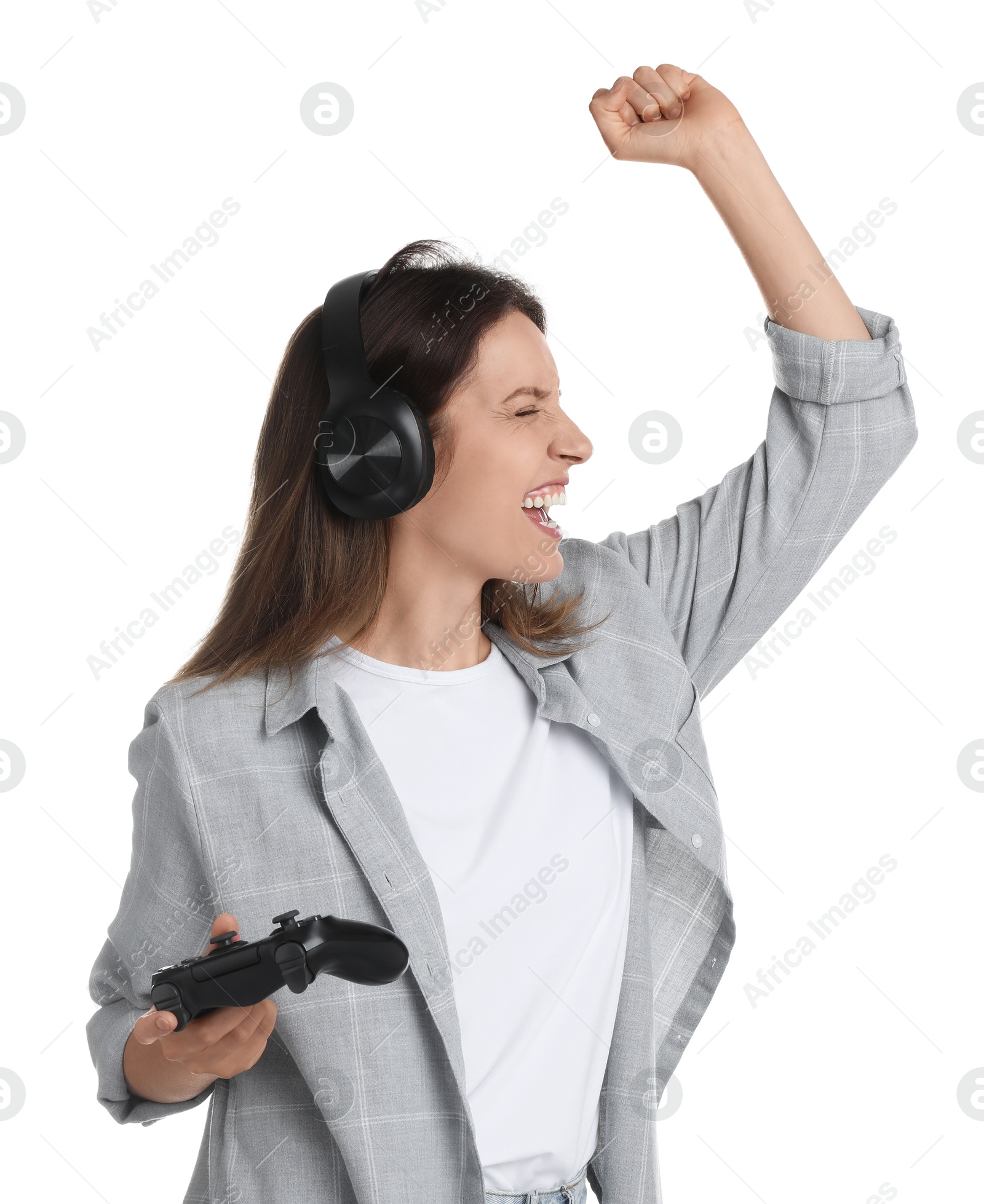 Photo of Happy woman in headphones with game controller on white background