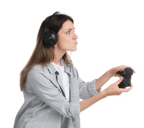 Woman in headphones playing video game with controller on white background