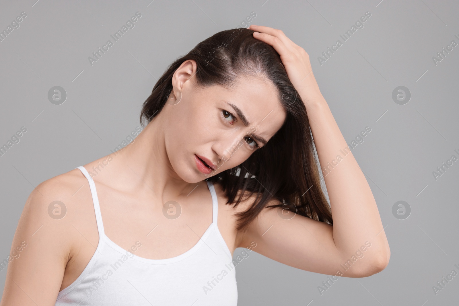 Photo of Sad woman with hair loss problem on grey background