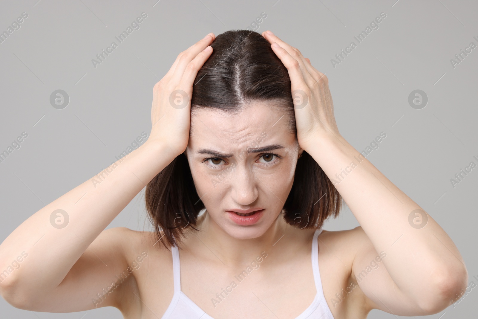 Photo of Sad woman with hair loss problem on grey background