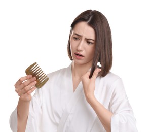 Stressed woman holding comb with lost hair on white background. Alopecia problem