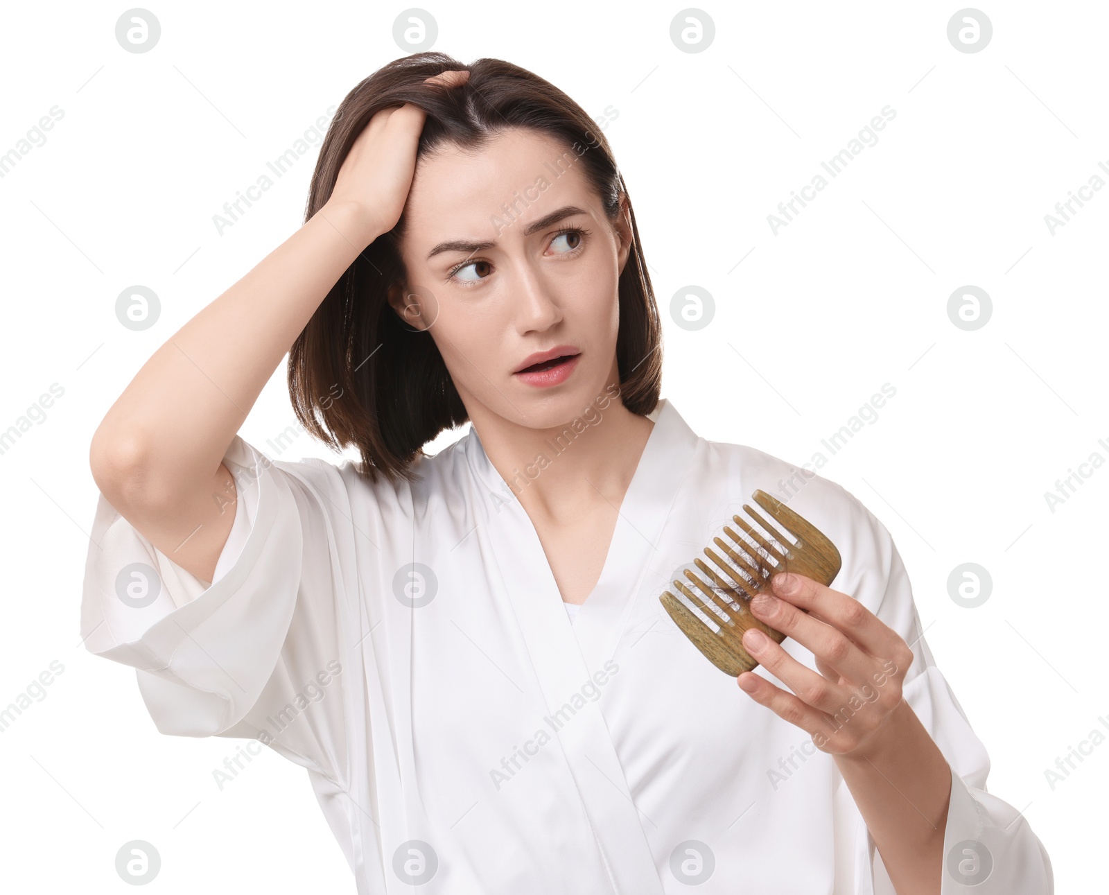 Photo of Stressed woman holding comb with lost hair on white background. Alopecia problem