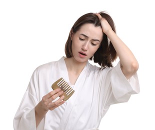 Photo of Stressed woman holding comb with lost hair on white background. Alopecia problem