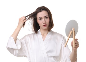 Photo of Sad woman with hair loss problem looking at mirror on white background