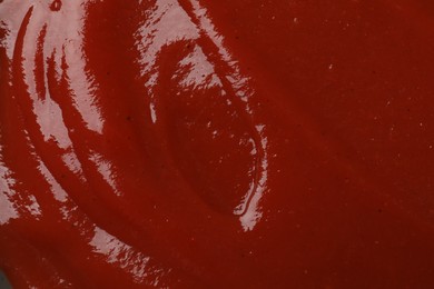 Texture of tasty ketchup as background, top view. Tomato sauce