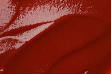 Photo of Texture of tasty ketchup as background, top view. Tomato sauce