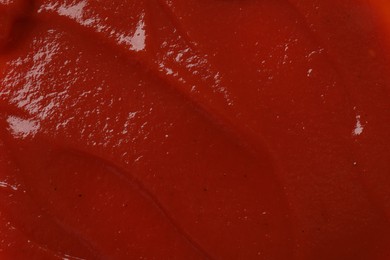 Photo of Texture of tasty ketchup as background, top view. Tomato sauce