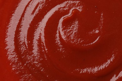 Texture of tasty ketchup as background, top view. Tomato sauce