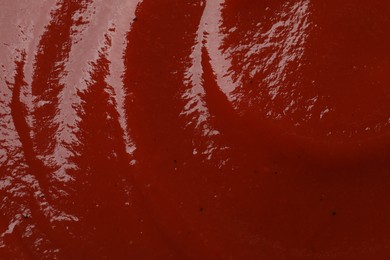 Photo of Texture of tasty ketchup as background, top view. Tomato sauce