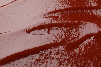 Photo of Texture of tasty ketchup as background, closeup. Tomato sauce