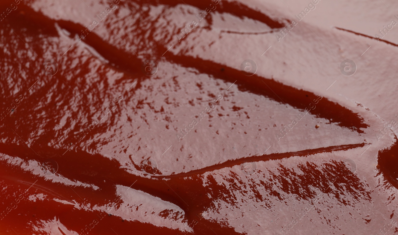 Photo of Texture of tasty ketchup as background, closeup. Tomato sauce