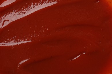 Texture of tasty ketchup as background, top view. Tomato sauce