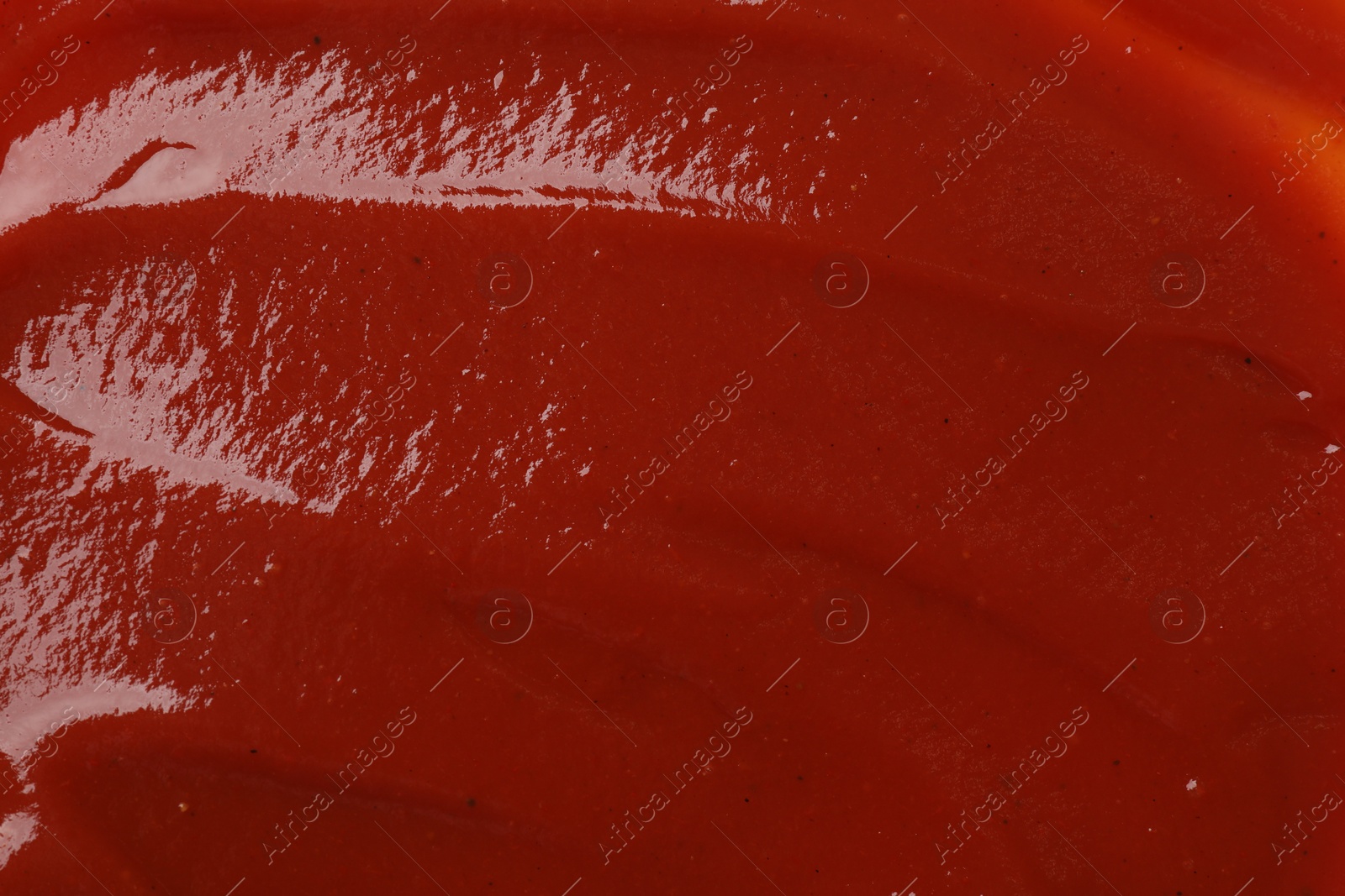 Photo of Texture of tasty ketchup as background, top view. Tomato sauce