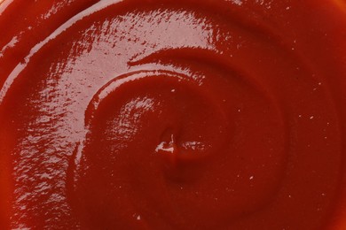 Photo of Texture of tasty ketchup as background, top view. Tomato sauce
