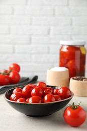 Photo of Tasty pickled tomatoes, fresh vegetables and spices on light grey table