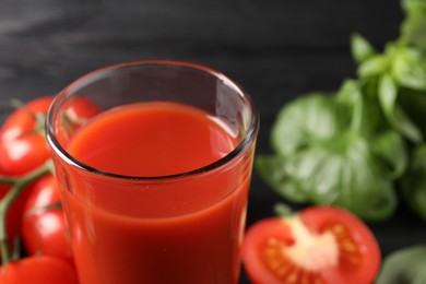 Fresh tomato juice in glass on table, closeup