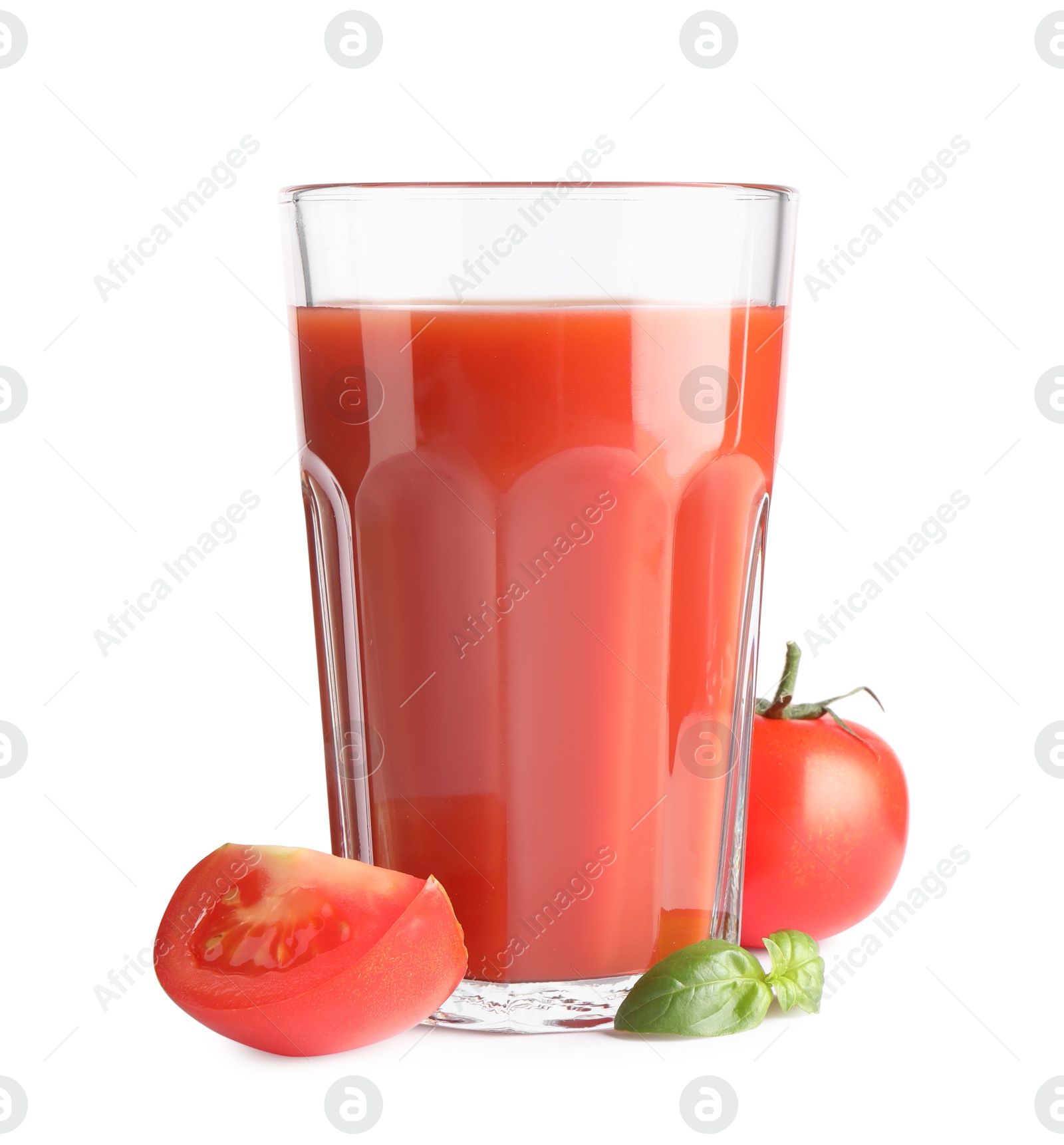 Photo of Tasty tomato juice in glass, basil and fresh vegetables isolated on white