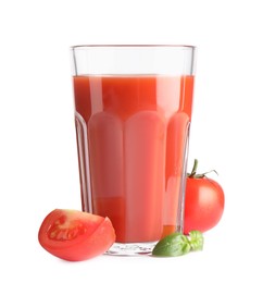 Photo of Tasty tomato juice in glass, basil and fresh vegetables isolated on white