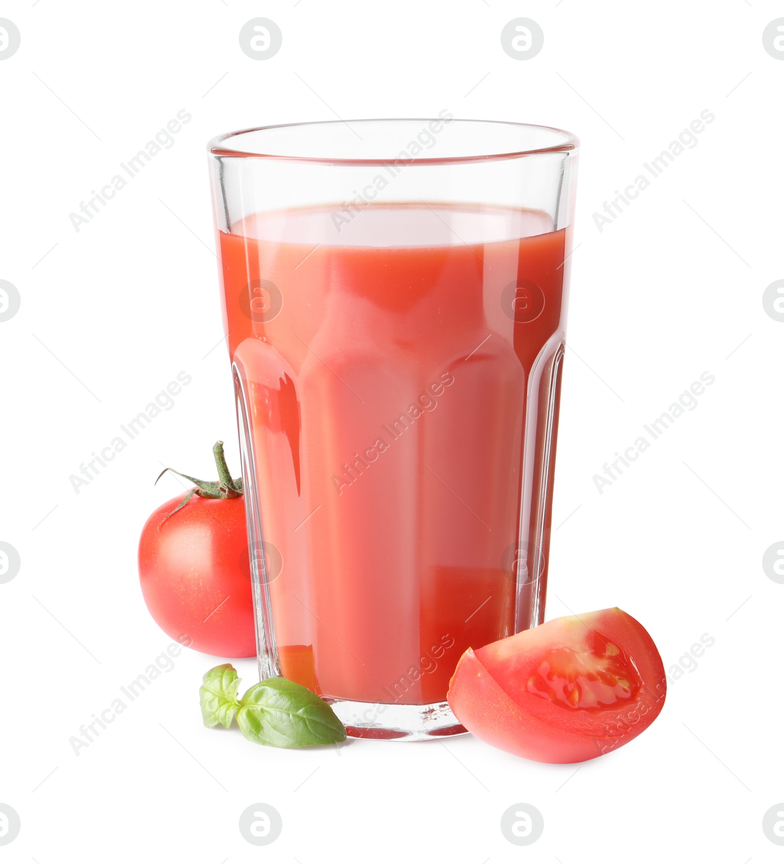 Photo of Tasty tomato juice in glass, basil and fresh vegetables isolated on white