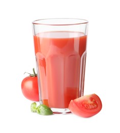 Photo of Tasty tomato juice in glass, basil and fresh vegetables isolated on white