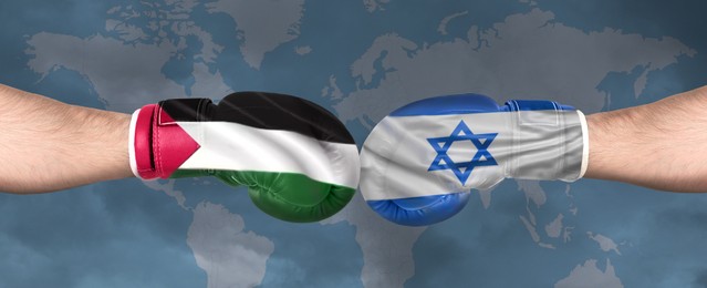Image of Political conflict, banner design. Men in boxing gloves with flags of Israel and Palestine fighting against world map, closeup