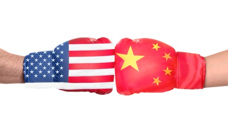 Political conflict. Men in boxing gloves with flags of USA and China fighting on white background, closeup