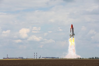 Image of Launch of space rocket in field on sunny day