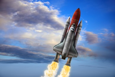 Image of Modern space rocket in beautiful cloudy sky