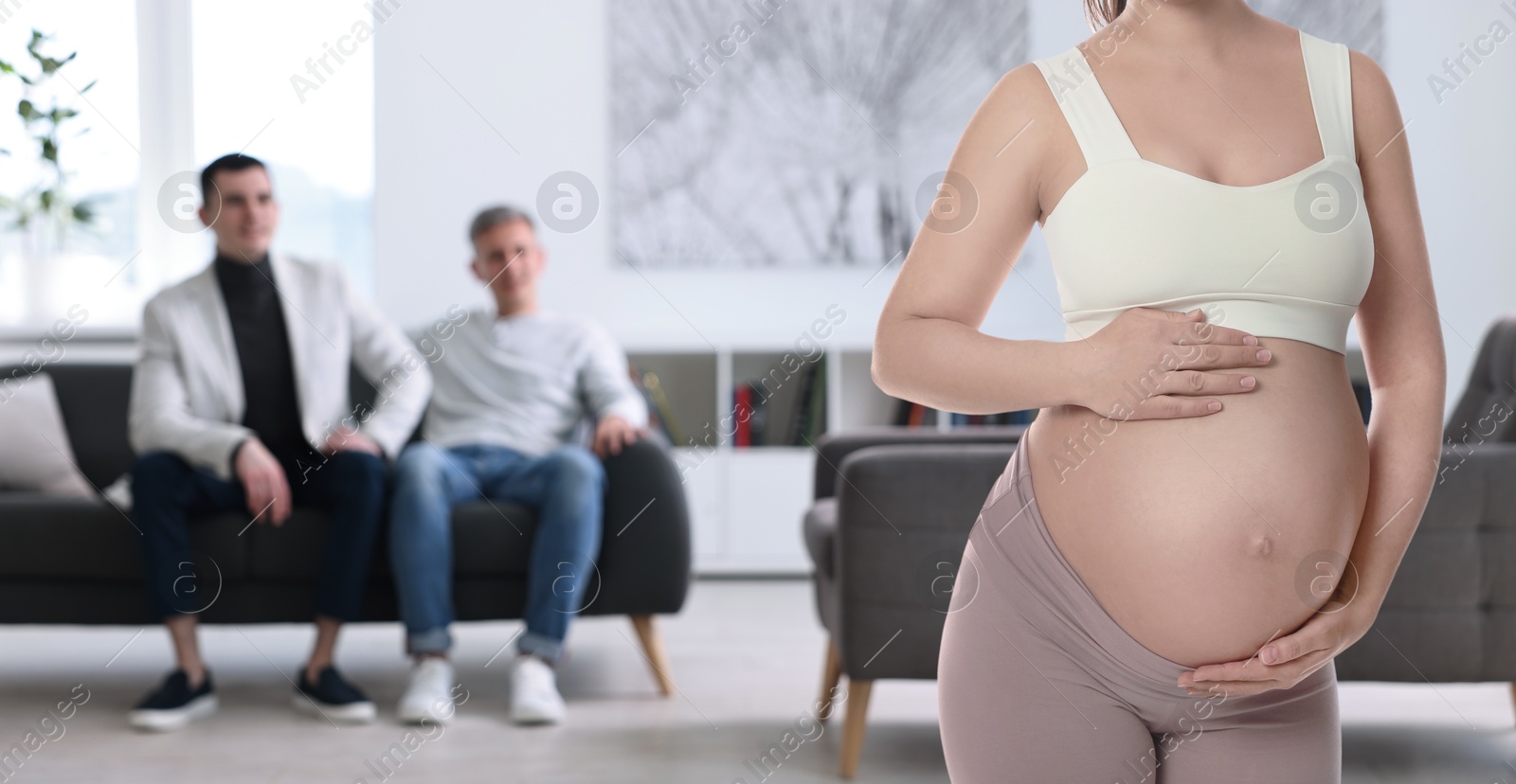 Image of Pregnant surrogate mother and happy gay couple at home, selective focus