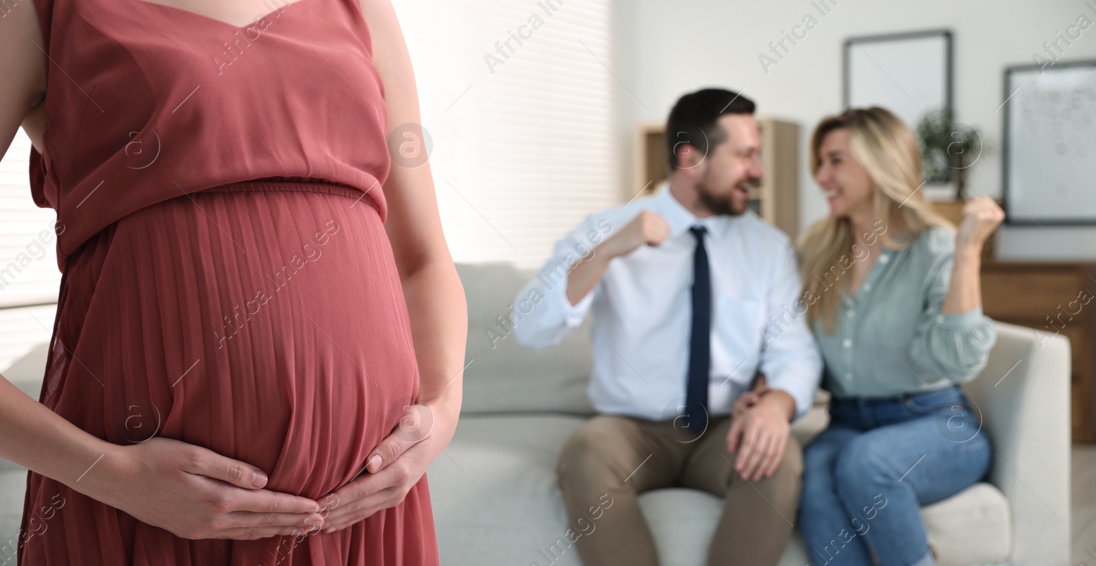 Image of Pregnant surrogate mother and happy couple at home, selective focus