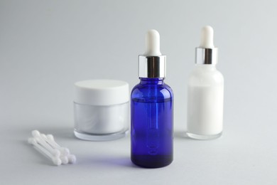 Bottles of chemical peel, jar and cotton swabs on light background. Peeling procedure