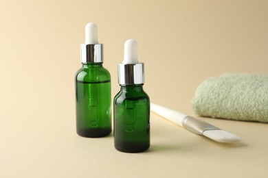 Bottles of chemical peel, towel and brush on beige background. Peeling procedure