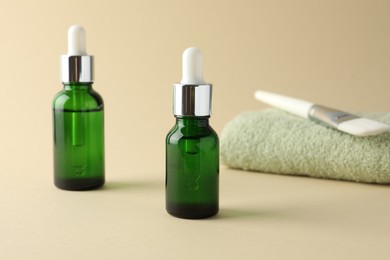 Bottles of chemical peel, towel and brush on beige background. Peeling procedure