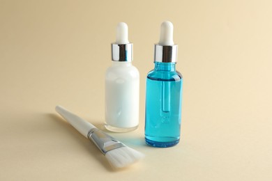 Bottles of chemical peel and brush on beige background. Peeling procedure