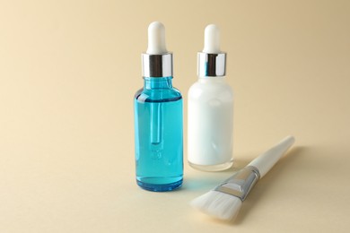 Bottles of chemical peel and brush on beige background. Peeling procedure