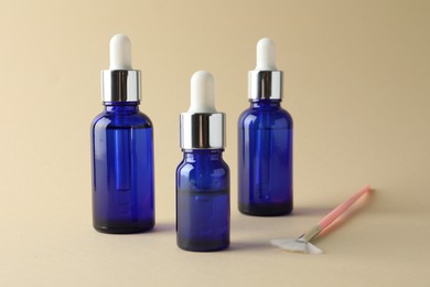 Bottles of chemical peel and brush on beige background. Peeling procedure