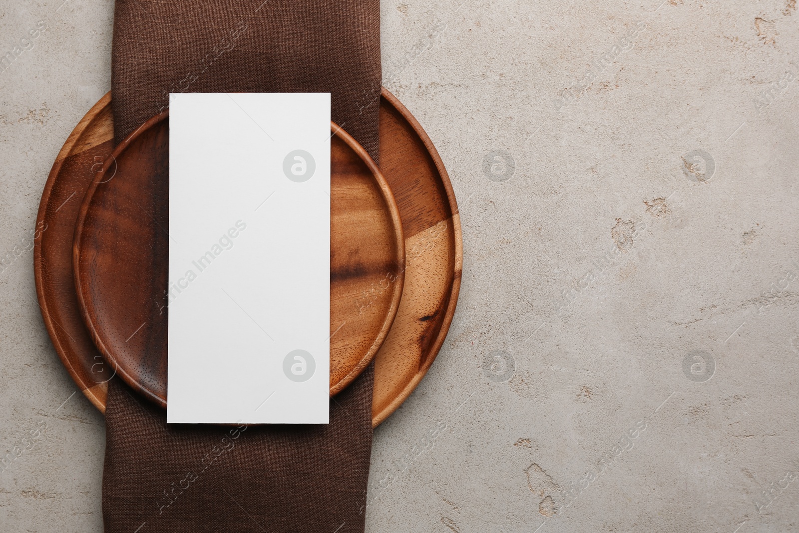 Photo of Empty menu and plates on light grey table, top view. Mockup for design