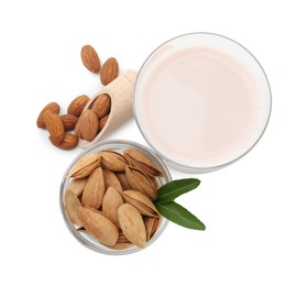 Photo of Glass of almond milk and almonds isolated on white, top view