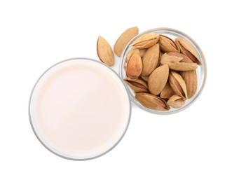 Glass of almond milk and almonds isolated on white, top view