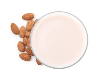 Glass of almond milk and almonds isolated on white, top view